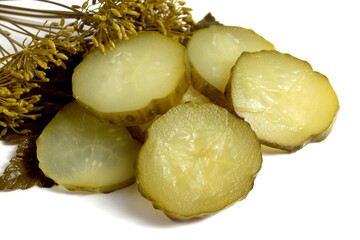 Pieces of pickled cucumber lie on a white background.