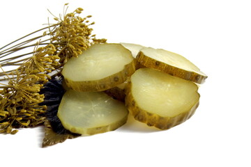 Pieces of pickled cucumber lie on a white background.	