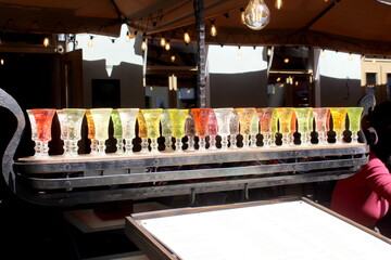 There are glass glasses with many different alcoholic drinks.