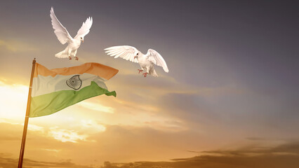 Indian flag waving in the sky with a flying pigeon bird and a sunrise scene background. India Independence Day