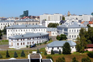 View of a city with houses and trees on a sunny hot summer day.	