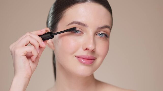 Beauty woman applying black mascara on eyelashes with makeup brush. Eyelash extensions. makeup, cosmetics. beauty, skincare
