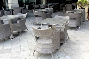 There are empty tables in the summer cafe.