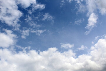 Background of blue bright sky with dark clouds.