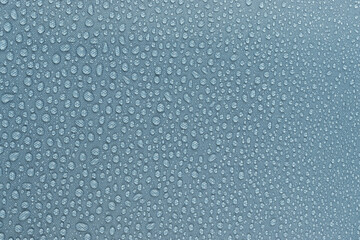 Water drops on the light blue fabric, horizontal