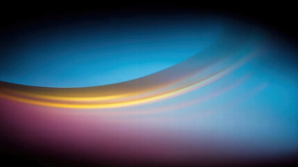 Smooth gradient of colors creates serene and calming atmosphere, blending shades of blue, yellow, and purple in harmonious flow. This abstract image evokes sense of tranquility and beauty