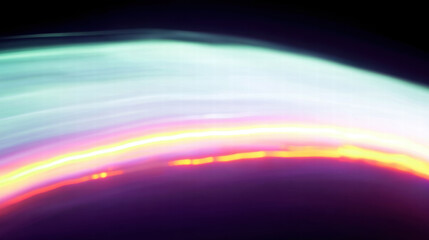 Abstract light trails create mesmerizing gradient of colors, blending smoothly from vibrant hues to soft tones, evoking sense of motion and energy