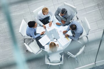 Senior female CEO leads multicultural team in strategic business meeting in modern office setting