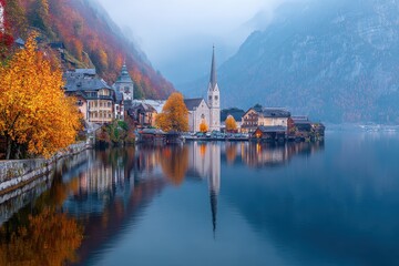 Misty autumn morning at Hallstatt lake with vibrant colors and tranquil reflections in calm waters