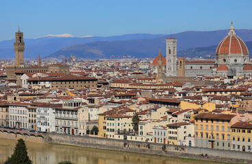 View of Florence in Central Italy with OLD PALACE and the Cathedral with Dome of Brunelleschi Architect and Italian Mountains with snow in background
