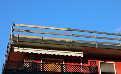 detail of the barrier with wooden planks firmly installed on the roof for the protection of workers against falling during the repair work of the condominium