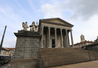 Grande Madre di Dio church in Turin with its grand staircase and a woman holding a chalice possibly the Holy Grail
