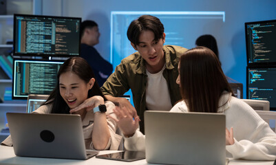 Young Asian business people working late into the night in the office, meeting, brainstorming, presentation working about coding