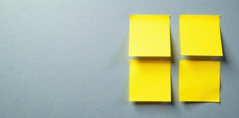 Close-up of four yellow sticky notes on a textured gray surface Clean, simple aesthetic , organization, note taking