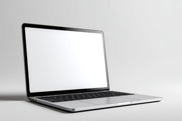 Blank white screen laptop placed on a white surface in a bright room showcasing minimalism and modern design aesthetics for creative technology use