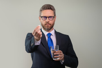 Tired, headache and eye strain. Businessman with stress, burnout and fatigue eyestrain. Business man rubbing tired eyes in studio. Man taking a medicine pill from headache migraine.