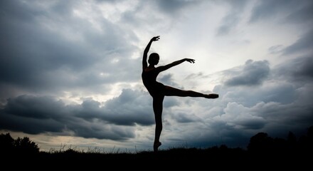 Fototapeta premium Graceful ballerina performs a dynamic pose against a dramatic cloudy sky capturing the essence of movement and artistry silhouette