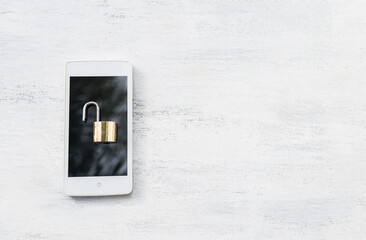 Padlock on smartphone on white wood background, mobile security and safety