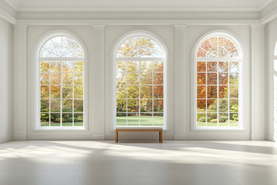 Bright and spacious room with large windows showcasing fall foliage in a serene landscape setting