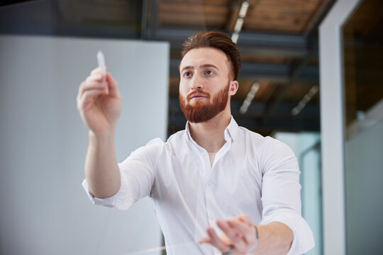 Young man working on invisible touchscreen at office