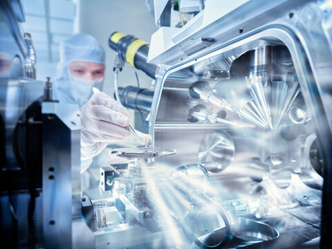 Technician scanning electron microscopes in laboratory - Powered by Adobe