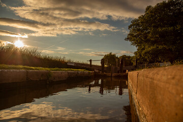 Canal lock gate on the Shropshire Union canal,. England, in early evening sunlight. Inland waterway holiday concept.