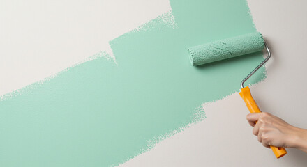 Painting wall with green roller