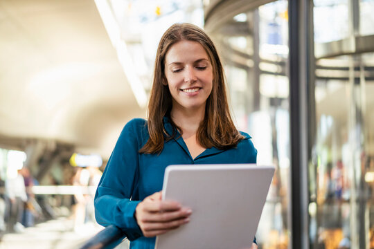 Smiling businesswoman using tablet PC in office