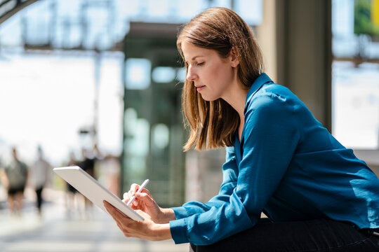 Businesswoman working on tablet PC with digitized pen