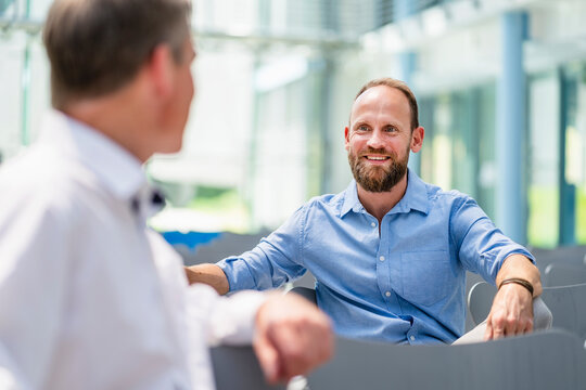 Confident businessman meeting colleague in company auditory