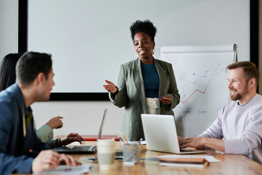 Businesswoman asking doubt to colleague in meeting at office