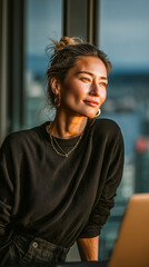 A focused woman works at a laptop in a clean, sunlit tech office. Ideal for startup, leadership, or productivity themes.