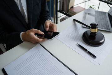 Lawyers meeting with legal counsel, holding lawyer's hammers