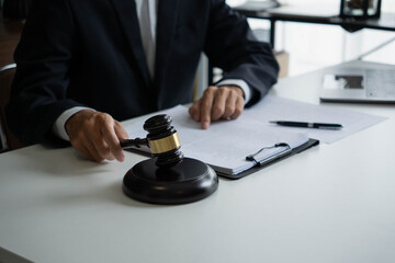 Lawyers meeting with legal counsel, holding lawyer's hammers