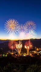 Fireworks display over mountains at night