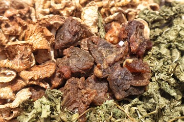 Close-up image of traditional dried Asian food ingredients, including dried meat chunks, dehydrated turnip slices, and dried mustard greens (saag). These preserved foods are commonly used in Asia