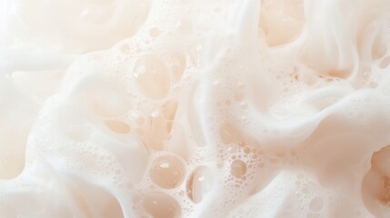 Abundant lather and bubbles, white and pale peach liquid swirling softly with foam, close up smooth texture for background