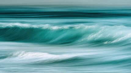 Fototapeta premium Turquoise waves gently roll onto the sandy beach, creating a soothing sound as they break. The sunset casts a warm glow over the scene, enhancing the serene ambiance.