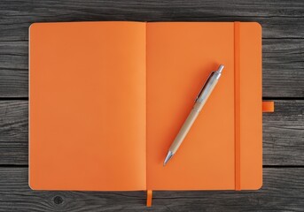 An open orange notebook with a pen lies on a wooden surface