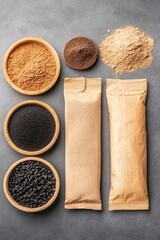 Various Powdered Substances in Bowls and Packages on a Gray Surface, Light Brown, Dark Brown, and Black Granules, Top View Flat Lay