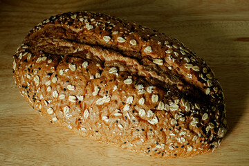 Whole Grain Bread Freshly baked bread topped with flax seeds and sunflower seeds