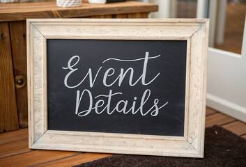 Fototapeta premium Rustic framed chalkboard displaying “Event Details” in cursive white chalk lettering