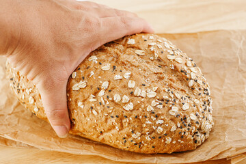 Whole Grain Bread Freshly baked bread topped with flax seeds and sunflower seeds