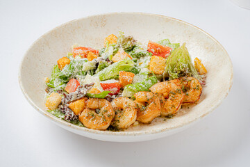 Vibrant shrimp salad features crisp greens, colorful veggies, and savory toppings in a rustic bowl