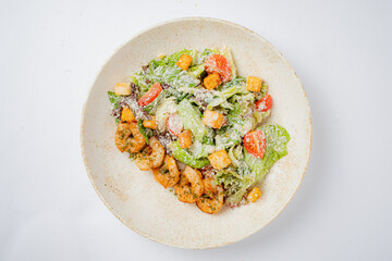 A delightful mix of shrimp, crisp lettuce, and colorful toppings served in a rustic bowl