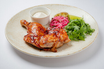 Juicy grilled chicken thigh served with vibrant greens, pickled onions, and zesty lime