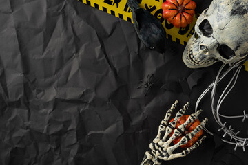 Halloween composition showcasing a spooky skeleton theme, featuring skulls, pumpkins, and black...