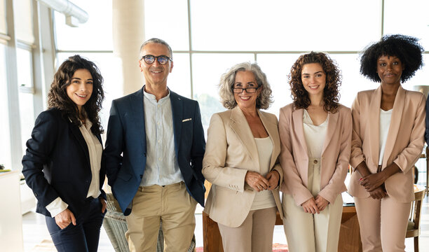 Confident multiracial business colleagues standing together at office