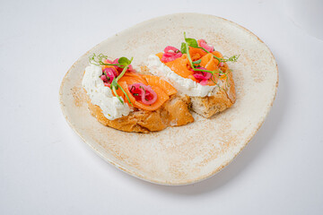 A stunning open-faced sandwich with smoked salmon, creamy cheese, and colorful toppings awaits