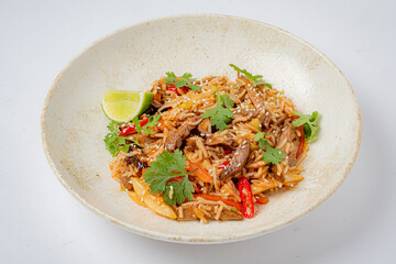 Savory stir-fried rice with tender meat, colorful peppers, fresh herbs, and lime